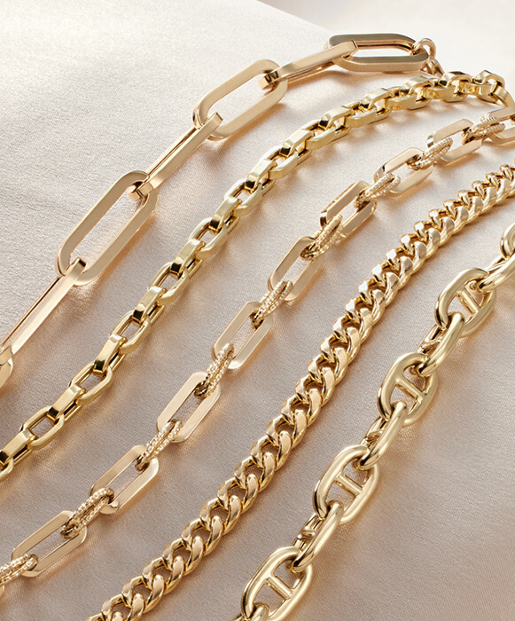 assorted diamond bracelets and necklaces stacked as gift jewelry